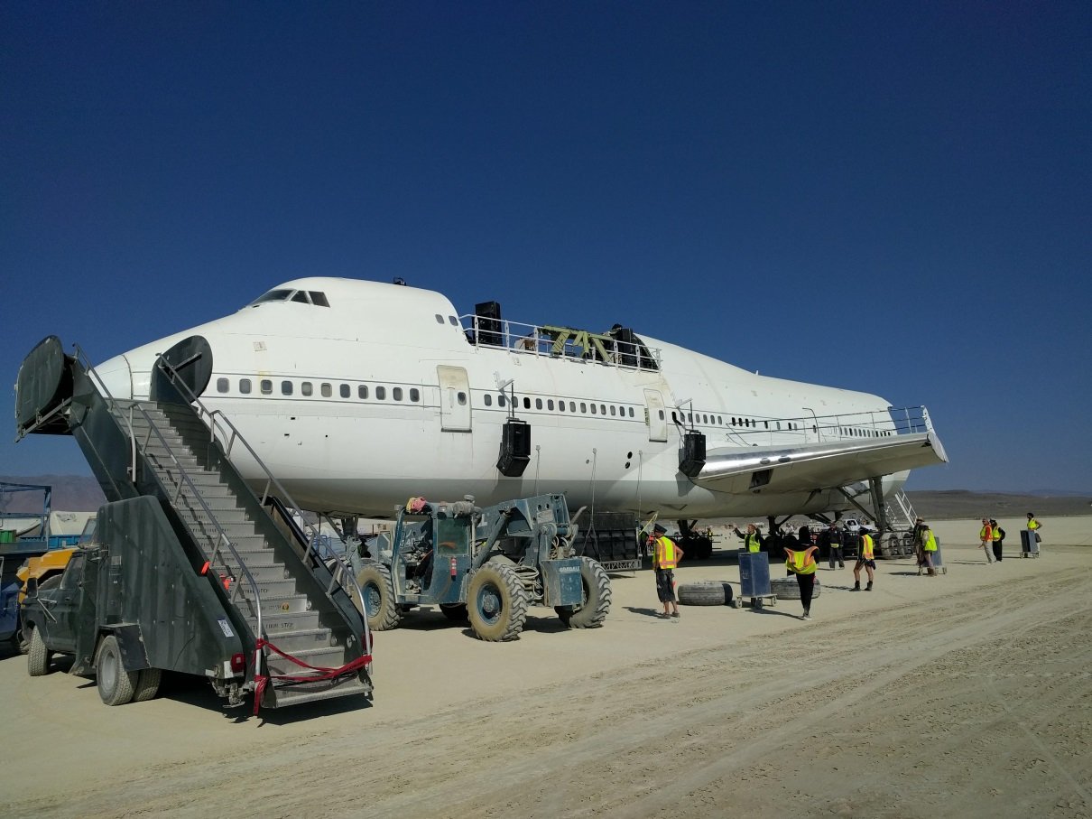 An actual Boing 747 that drives around the playa and serves as a dance floor at night 747