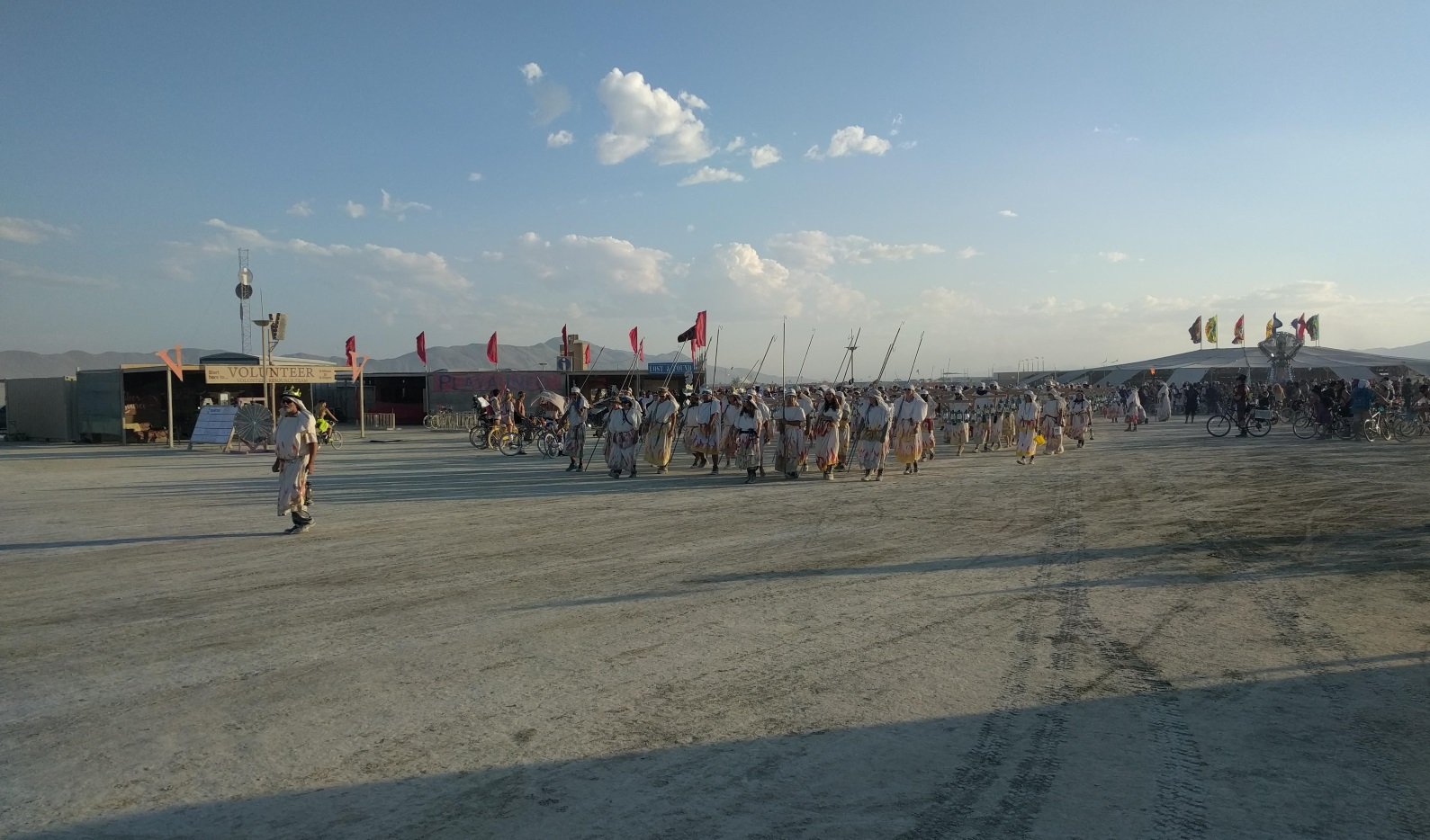 Lamplighters walk the playa as the hang hundreds of oil lamps to light up the main road for the night Lamplighters