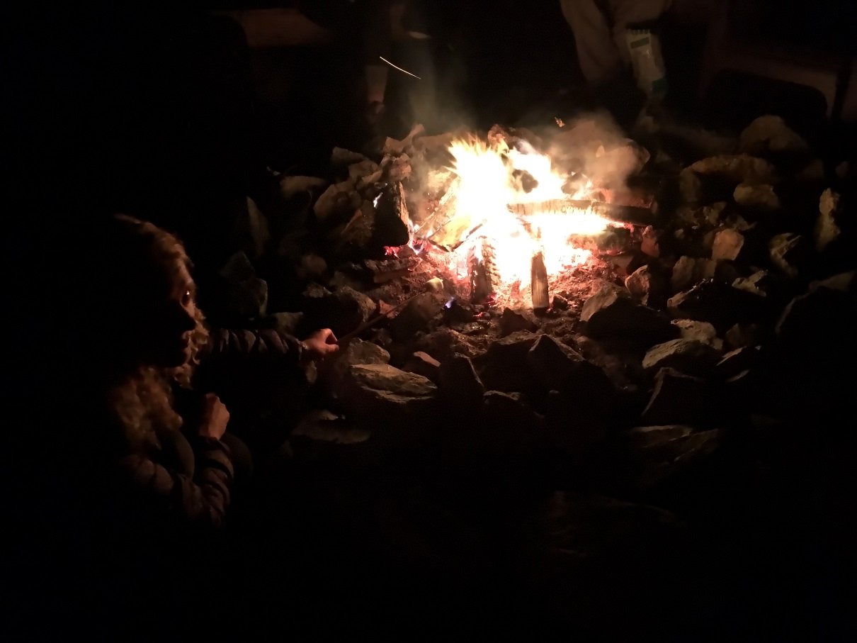 Campfire at night to share stories with drinks campfire
